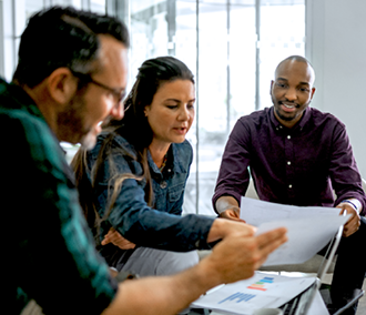 Casual meeting of diverse business team analyzing financial data